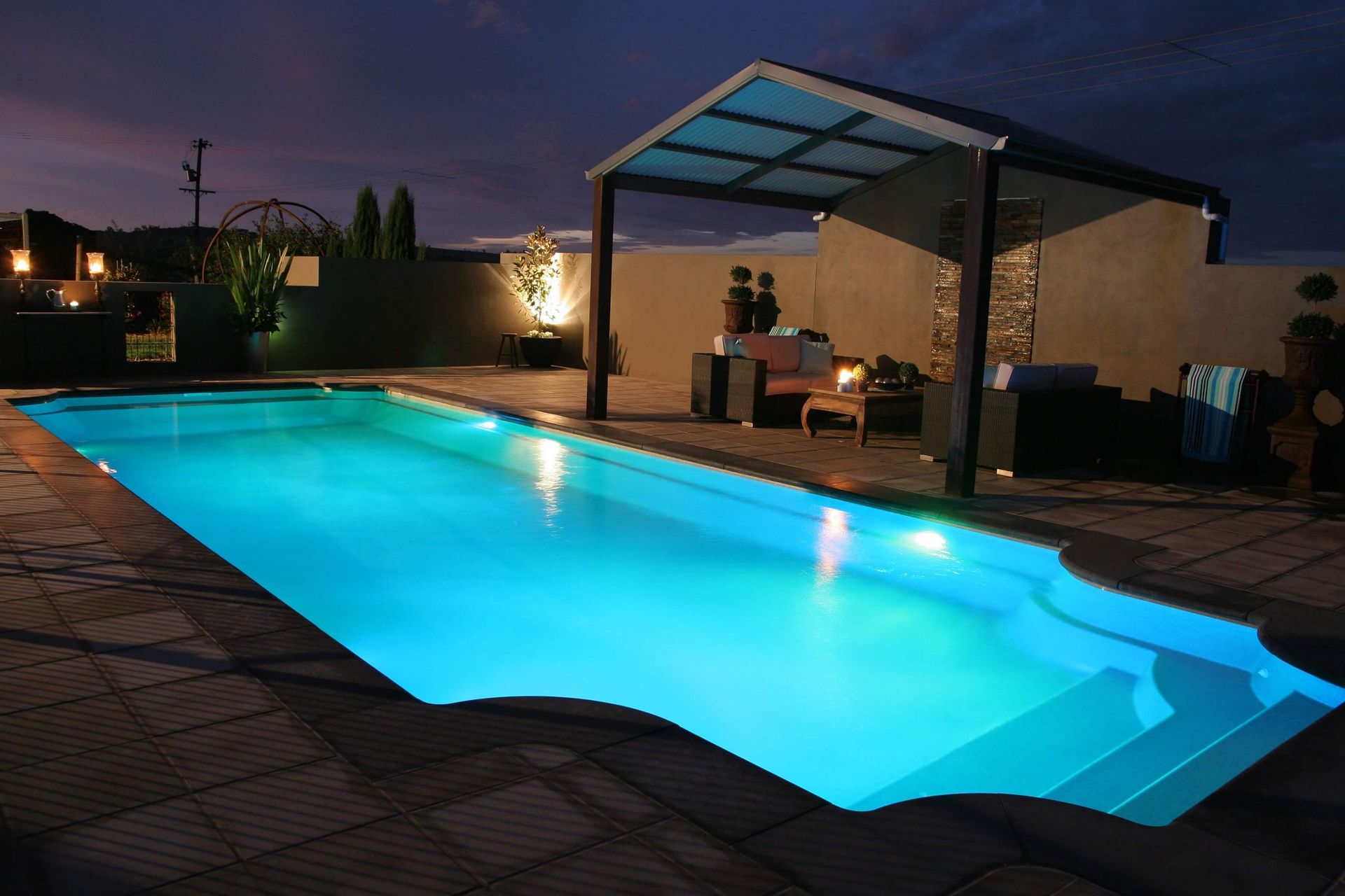 The Man Hand While Using Spacer For Installing Tiles And Tiled Pool — Professional Pool Builder in Wagga Wagga, NSW