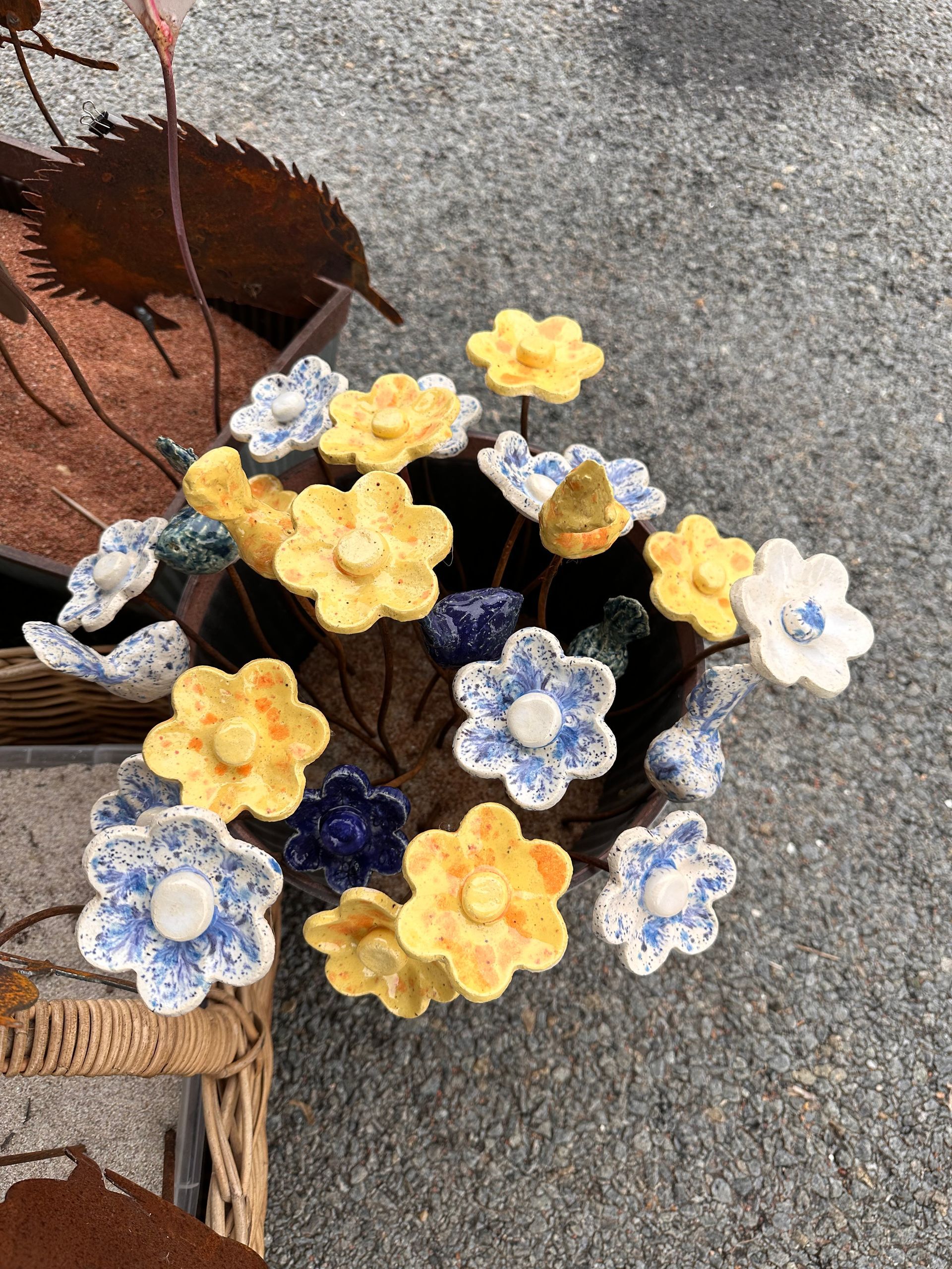 Blue and Yellow Flower Bouquet in a Woven Basket on Pavement — Professional Pool Builder in Wagga Wagga, NSW