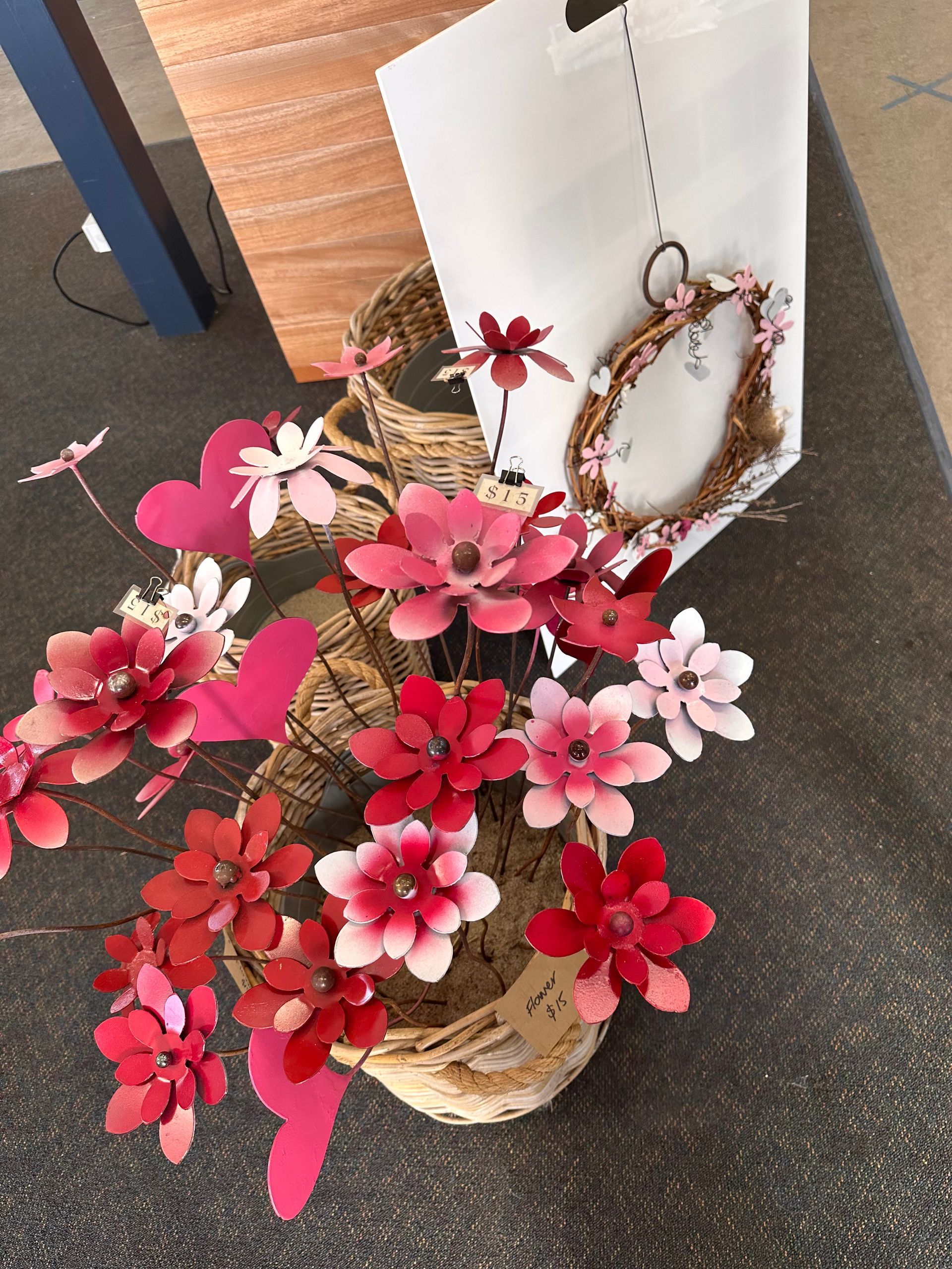 Basket of Pink and Red Artificial Flowers Beside a White Bag and Hanging — Professional Pool Builder in Wagga Wagga, NSW