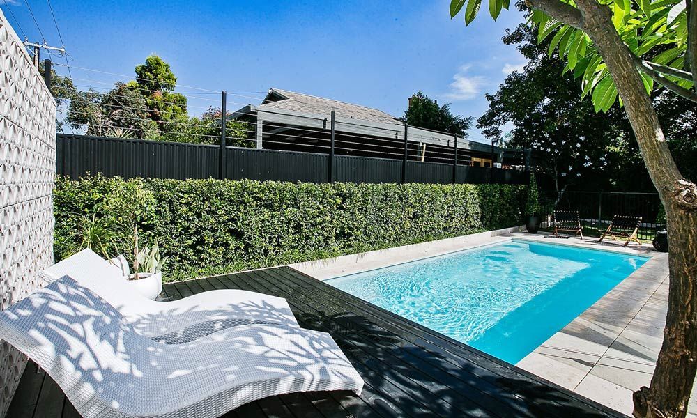 Modern White S-Shaped Bench And Swimming Pool — Professional Pool Builder in Wagga Wagga, NSW