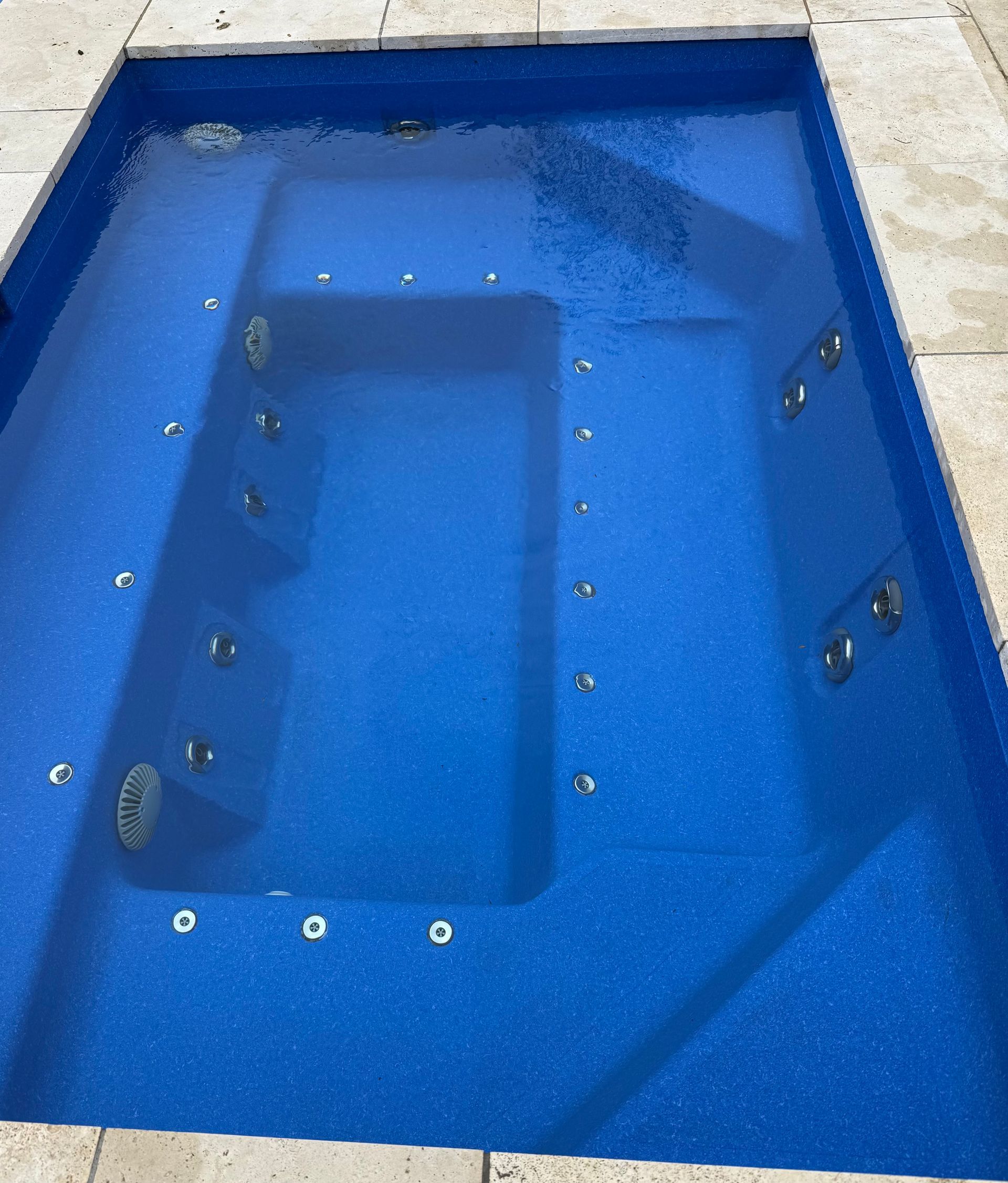 A Small Rectangular Pool With Blue Water — Professional Pool Builder in Wagga Wagga, NSW