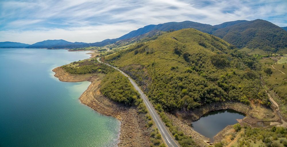 Rural Highway Along Tumut River Coastline And Mountains — Professional Pool Builder in Tumut, NSW