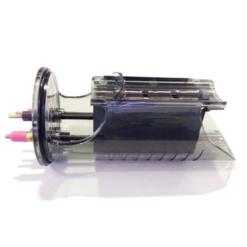 Clear plastic device with internal components, dark rectangle, and multiple protruding rods and connectors.