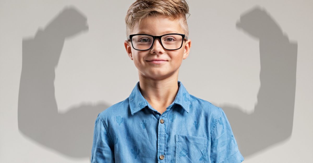 Boy in classes smiling confidently