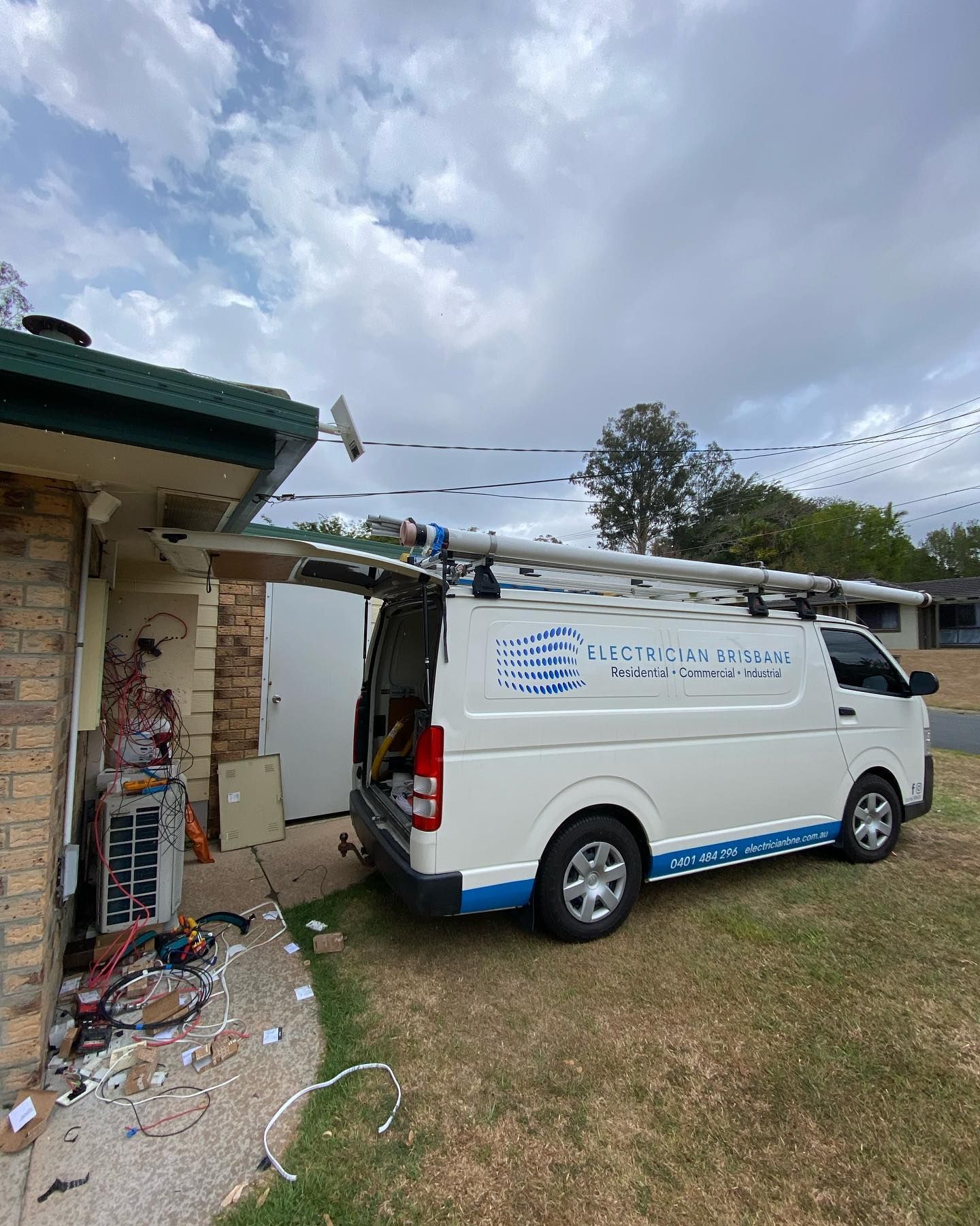 Electrician Brisbane service van beside a residential property