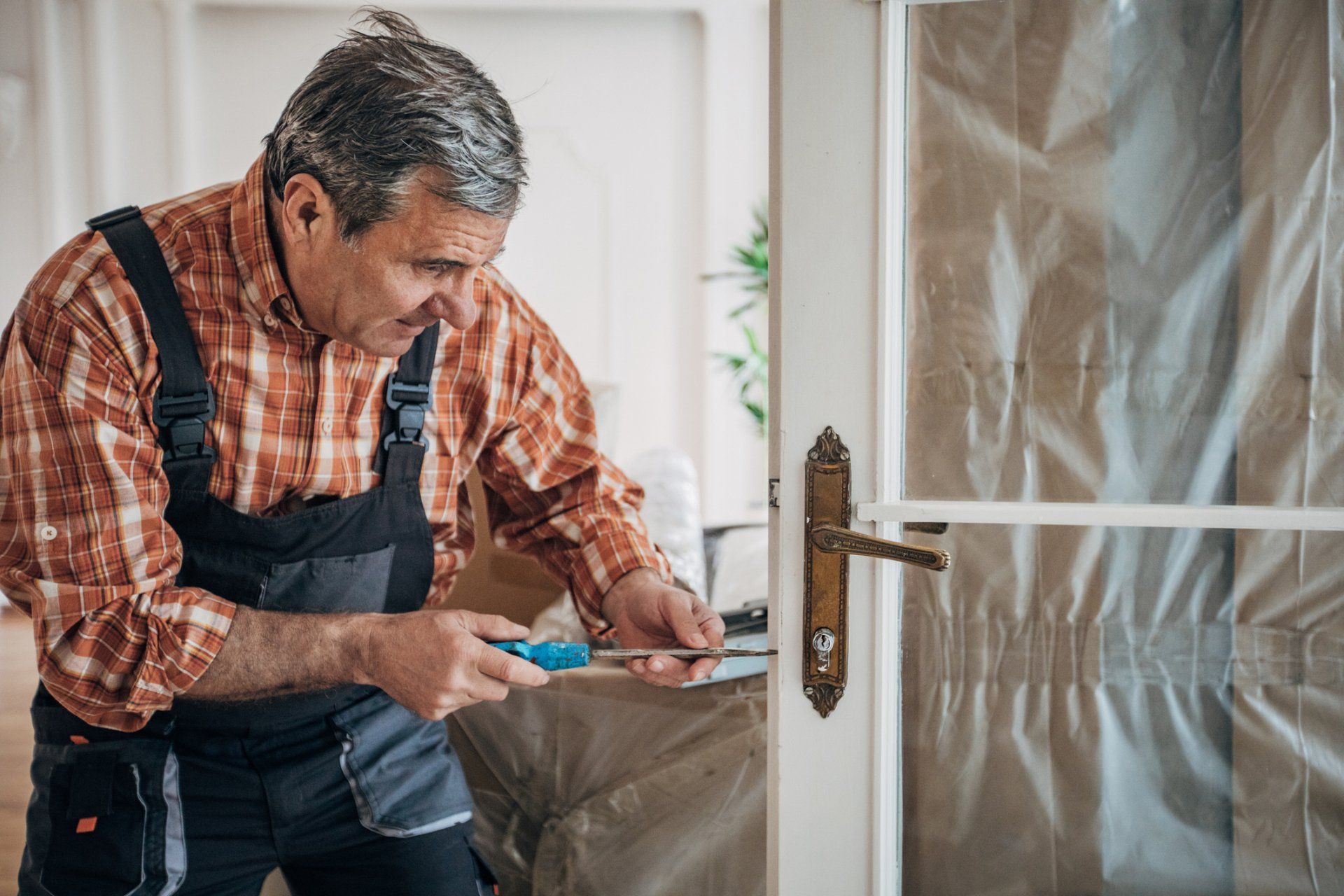 Carpenter Repairing The Door - Spooner, WI - Spooner Window & Door