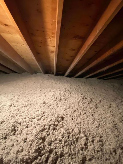 There is a lot of insulation in the attic of a house.