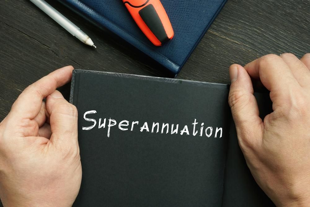 A Person Is Holding a Notebook with The Word Superannuation — Sunshine Coast Financial Advisers in Caboolture, QLD