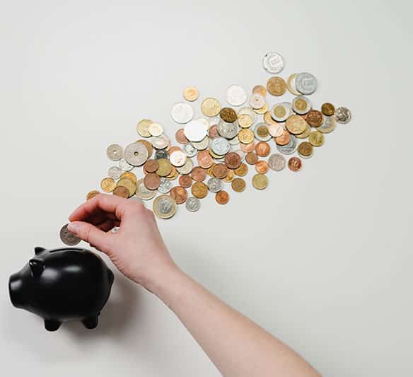 A Person Is Putting a Coin Into a Piggy Bank — Sunshine Coast Financial Advisers in Maroochydore, QLD