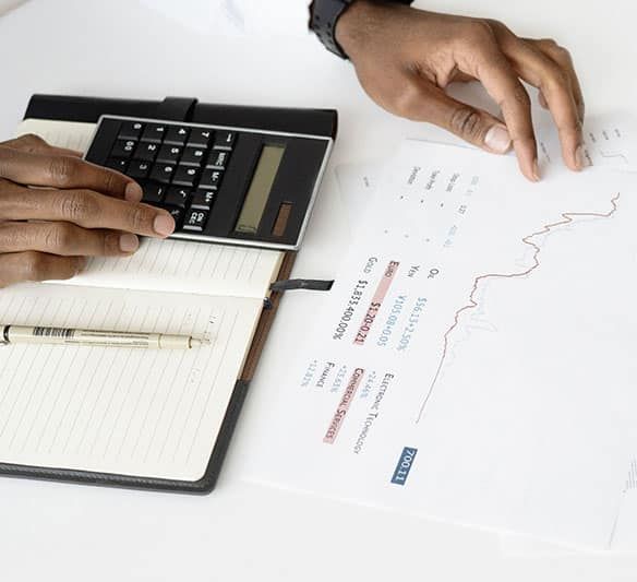 A Person Is Using a Calculator Next to A Notebook and Pen — Sunshine Coast Financial Advisers in Noosa, QLD
