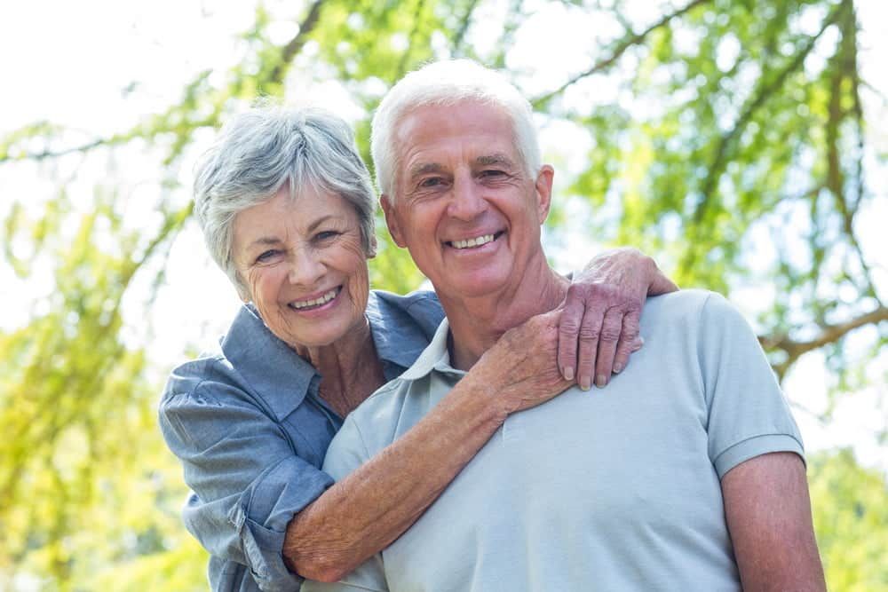 An Elderly Couple Is Posing for A Picture in A Park — Sunshine Coast Financial Advisers in Caloundra, QLD