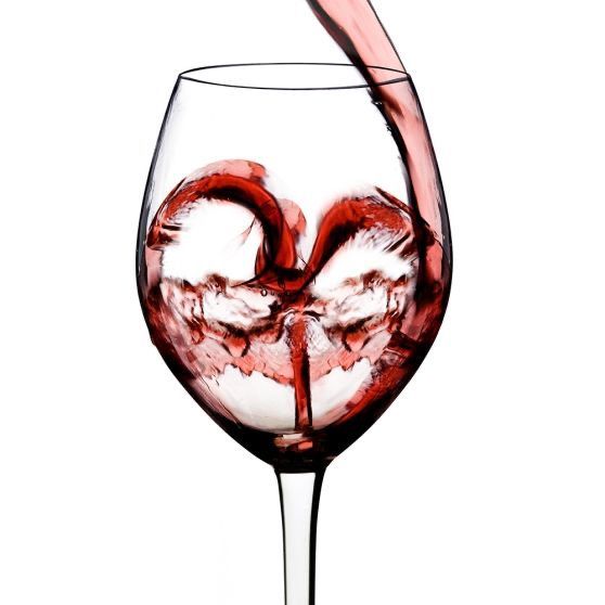 A glass of red wine with a heart in it