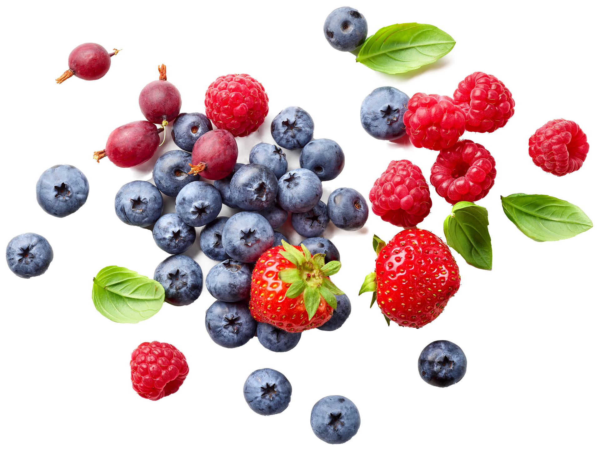 Assorted berries, including blueberries, raspberries, and strawberries, scattered on a white surface.