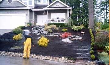 A man in yellow pants is standing in front of a house.