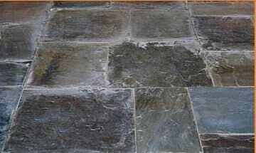 A close up of a tiled floor with a yellow border.