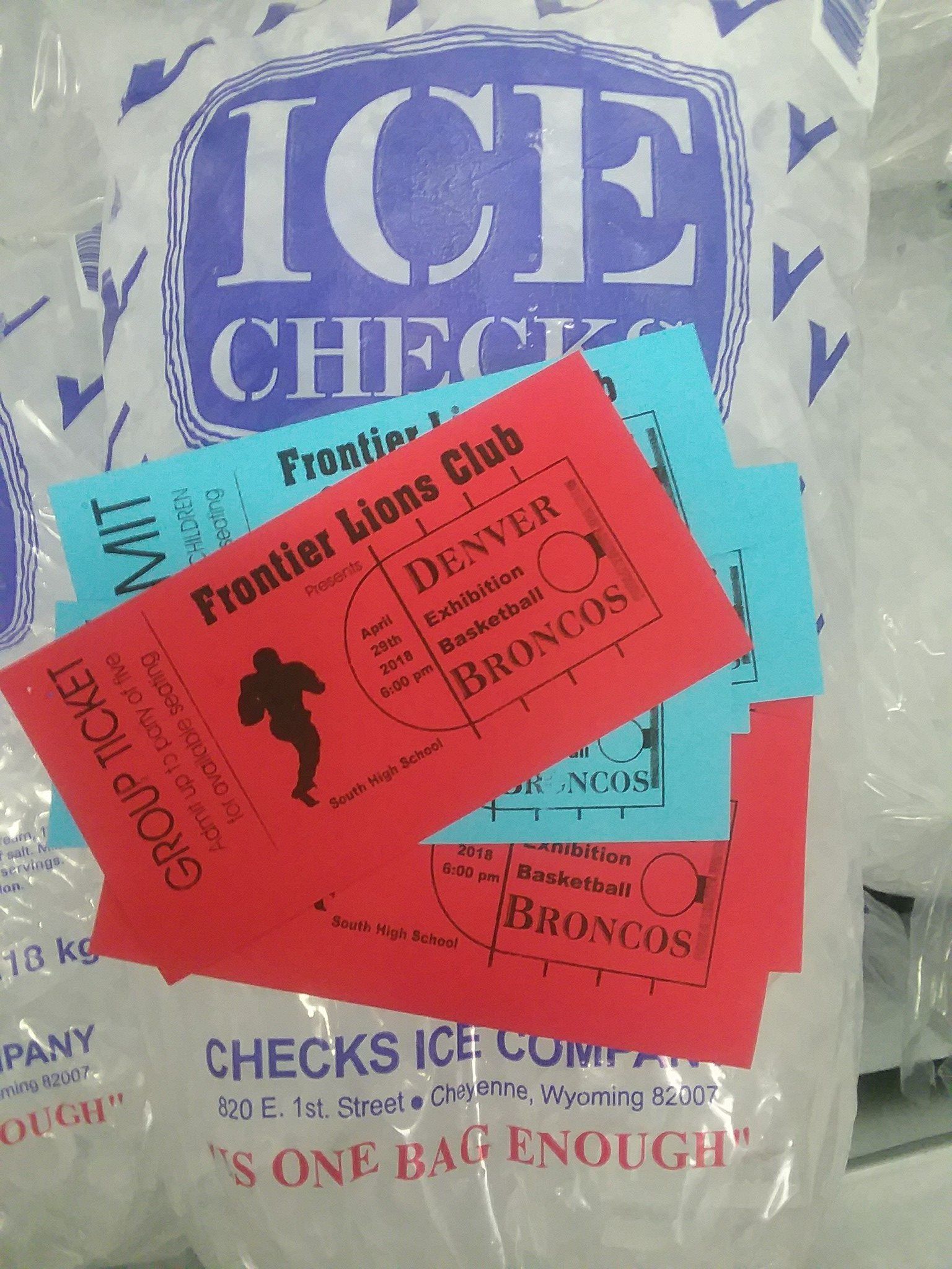 Red and blue tickets for Denver Broncos basketball, on ice bag labeled 