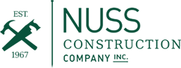 The Nuss Construction Company Inc. logo featuring crossed hammer and saw icons with the text
