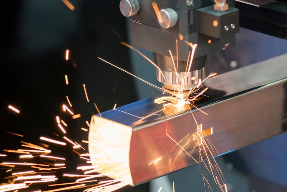 A Machine Is Cutting A Piece Of Metal With Sparks Coming Out Of It - Gold Coast Laser And Pipe Bending In Mudgeeraba, QLD