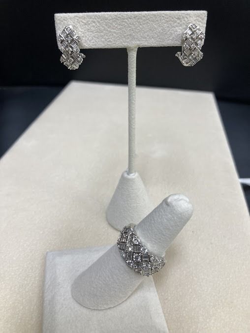 Diamond earrings and ring on display.