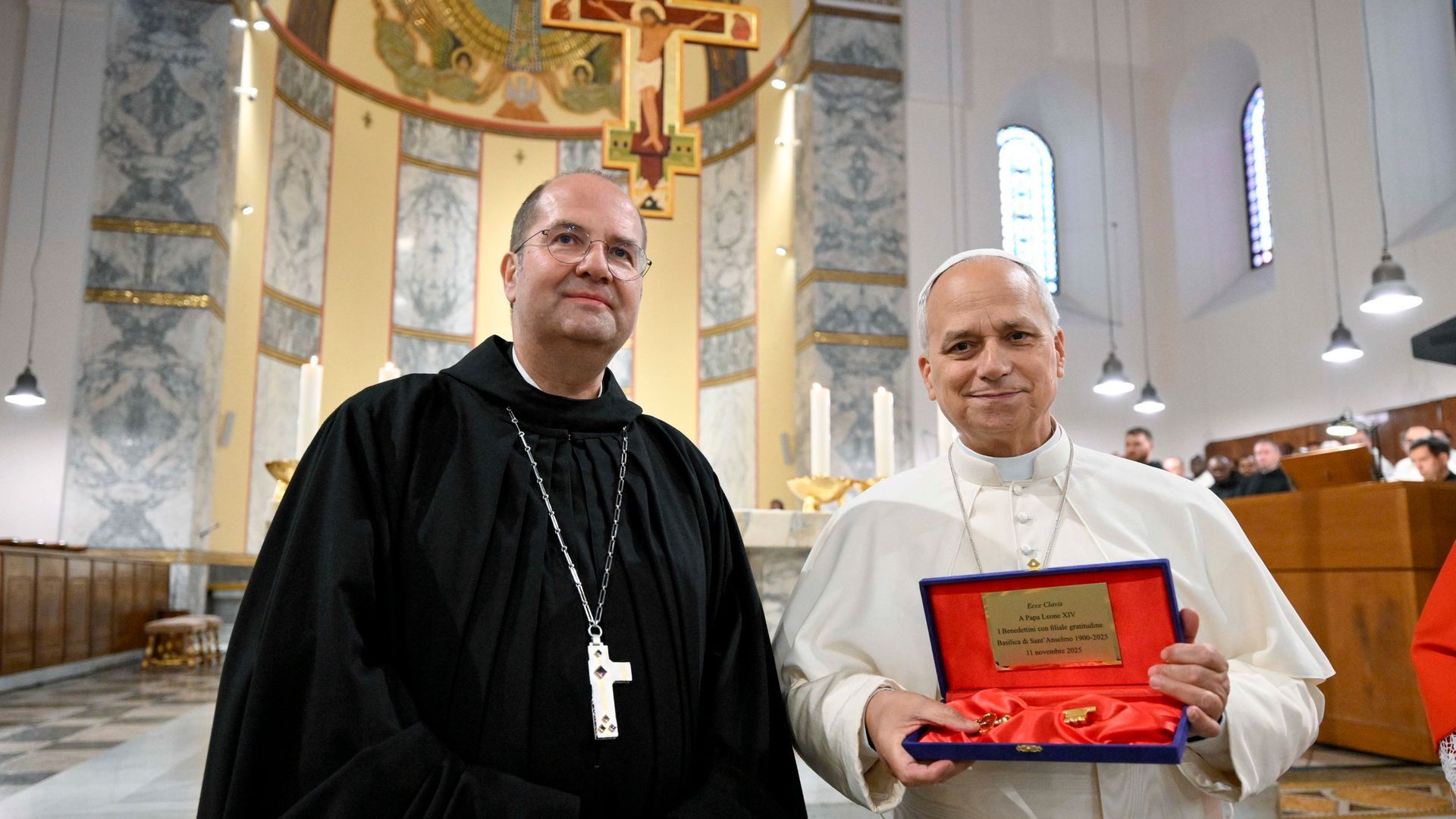 Pope Leo XIV receives the keys to Rome's Church of St. Anselm from Abbot Jeremias Schröder, abbot primate of the international Benedictine Confederation, Nov. 11, 2025, the 125th anniversary of the church's dedication. (CNS photo/Vatican Media)