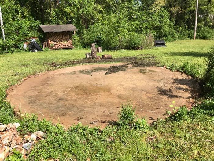 A circle of dirt in the middle of a grassy field.