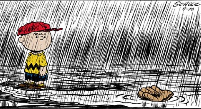 Hand drawn cartoon character, Charlie Brown, stands in rain. His glove is floating away.