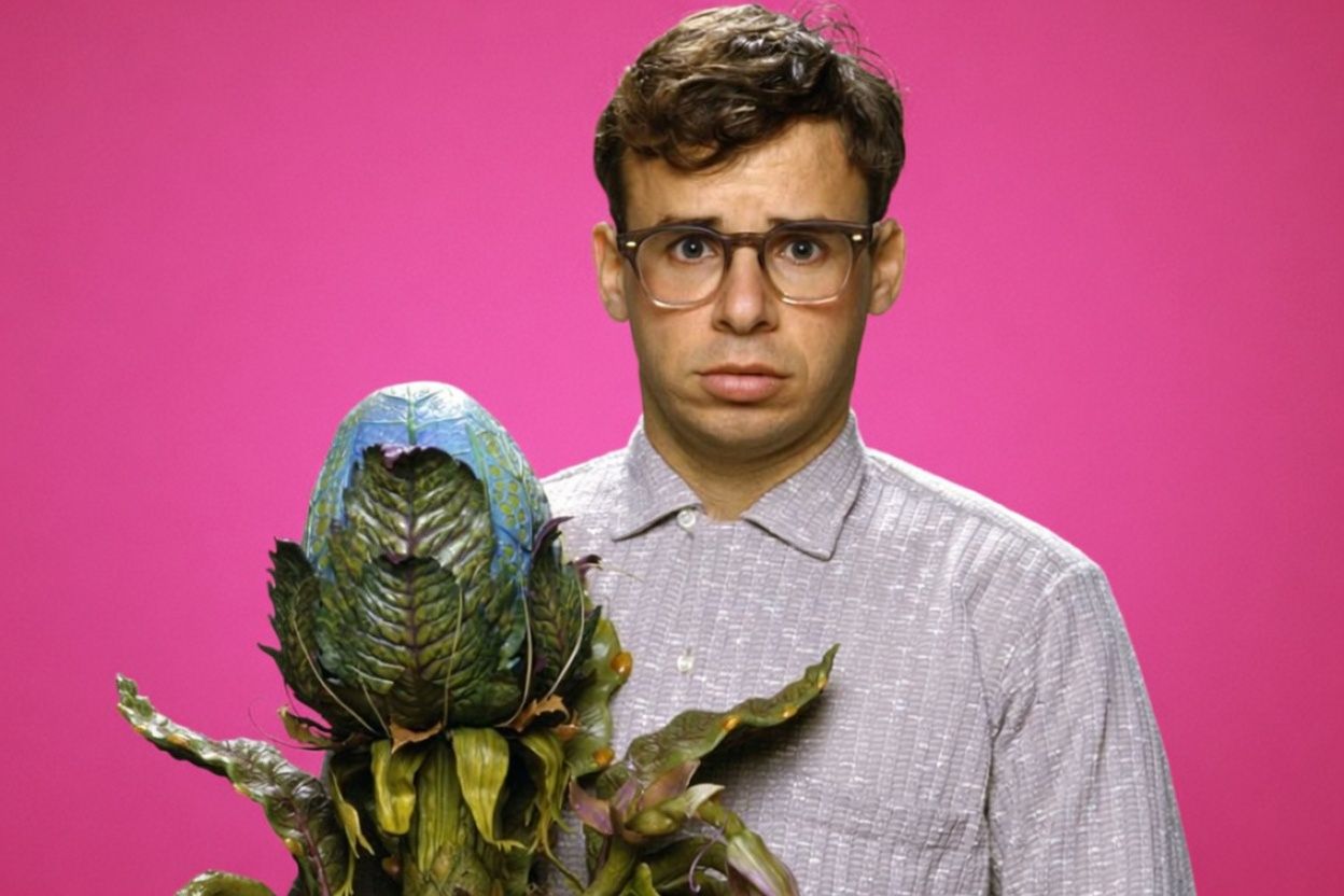 Rick Moranis as Seymour Krelborn with Audrey II in the 1986 musical comedy horror film Little Shop of Horrors.