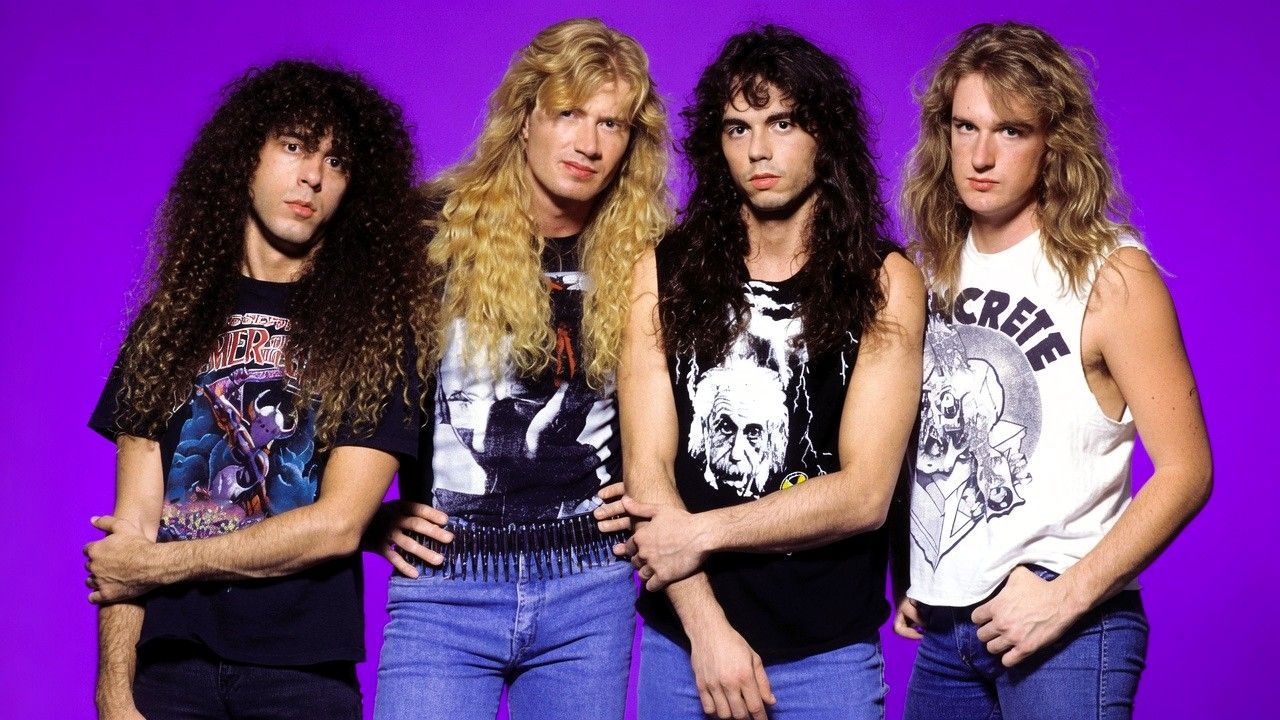 Classic Megadeth lineup in a studio portrait featuring Dave Mustaine alongside early band members against a vivid purple background.
