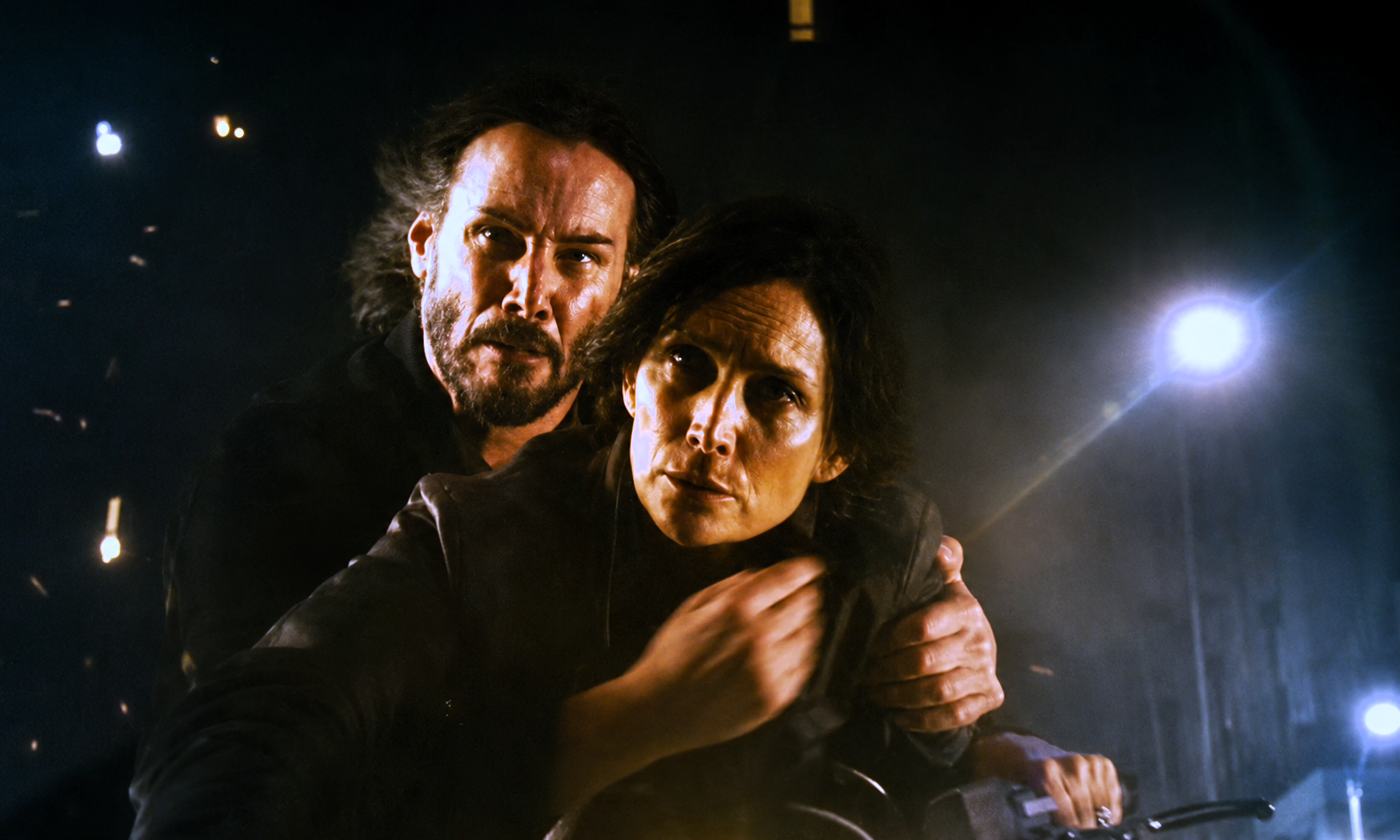 Keanu Reeves as Neo embraces Carrie-Anne Moss as Trinity in a scene from The Matrix Resurrections.
