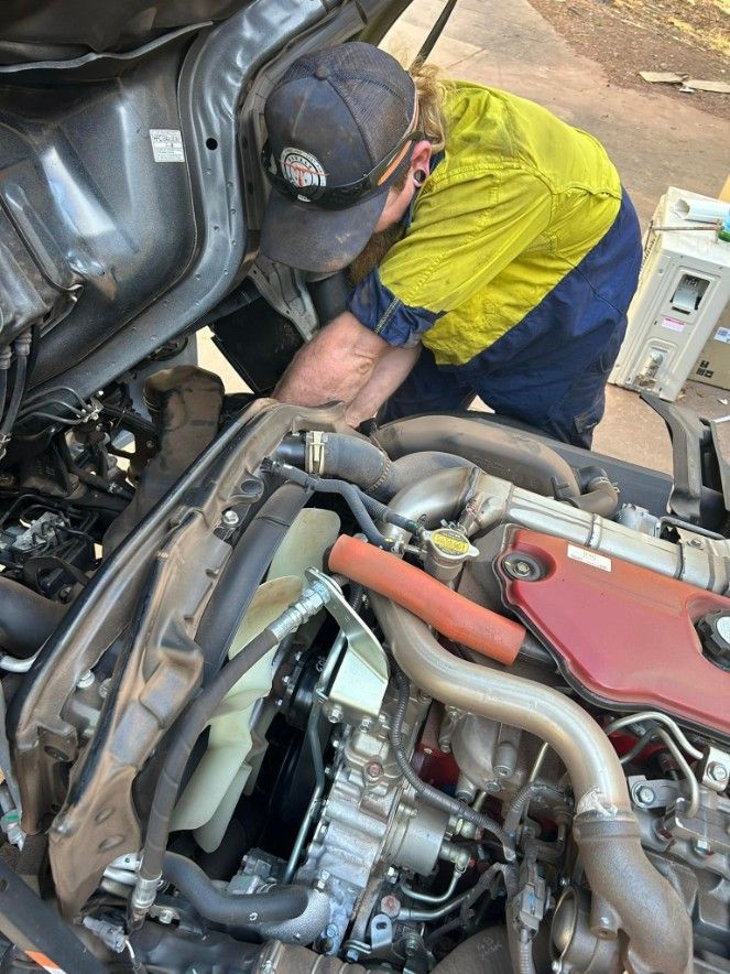 Mechanic Working on a Truck Engine, Wearing Work Clothes — Mudpig Mechanical In Humpty Doo, NT
