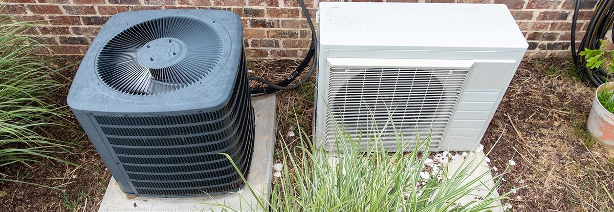 Outdoor AC units next to residential home - air conditioning repair service in Rosharon TX