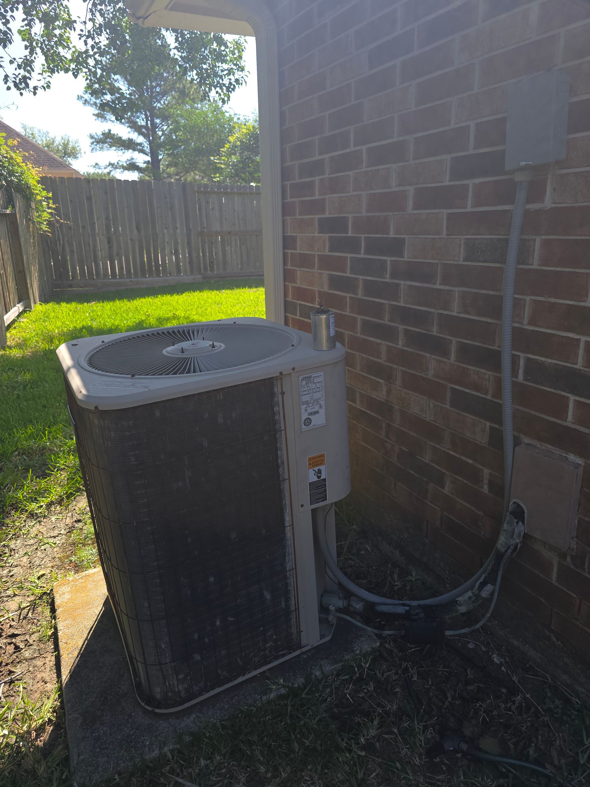HVAC refrigerant gauges showing pressure readings during AC service by Arnett Mechanical
