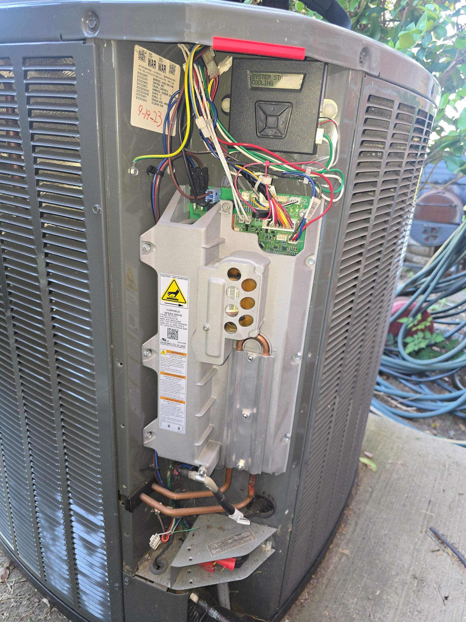 Outdoor AC units installed next to brick home by Arnett Mechanical in Rosharon TX
