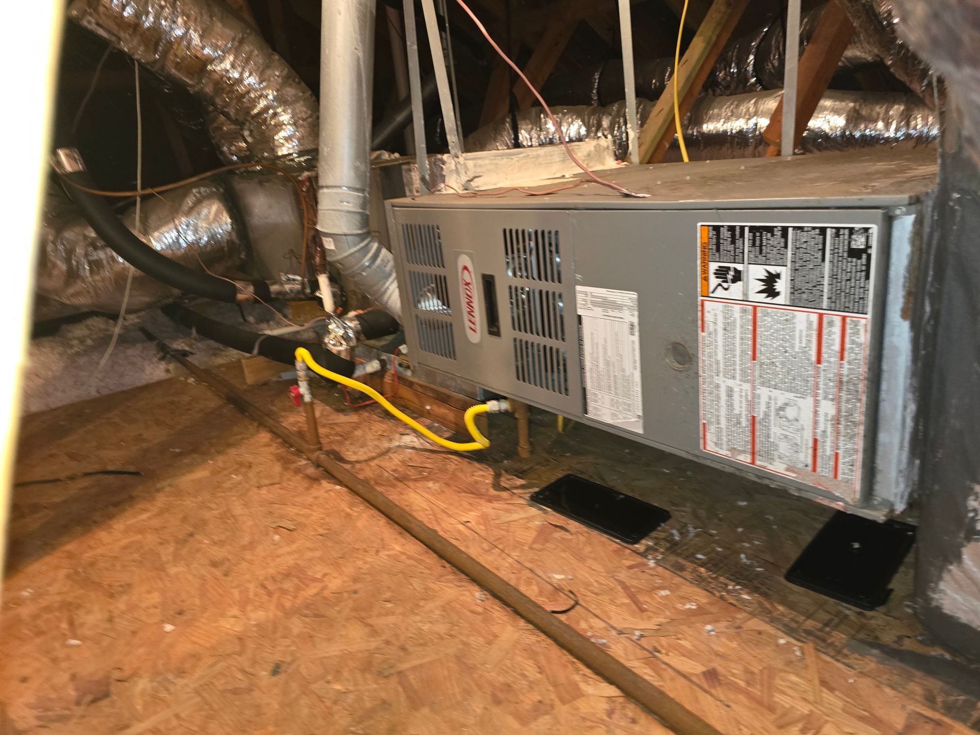 HVAC refrigerant gauges showing pressure readings during AC service by Arnett Mechanical