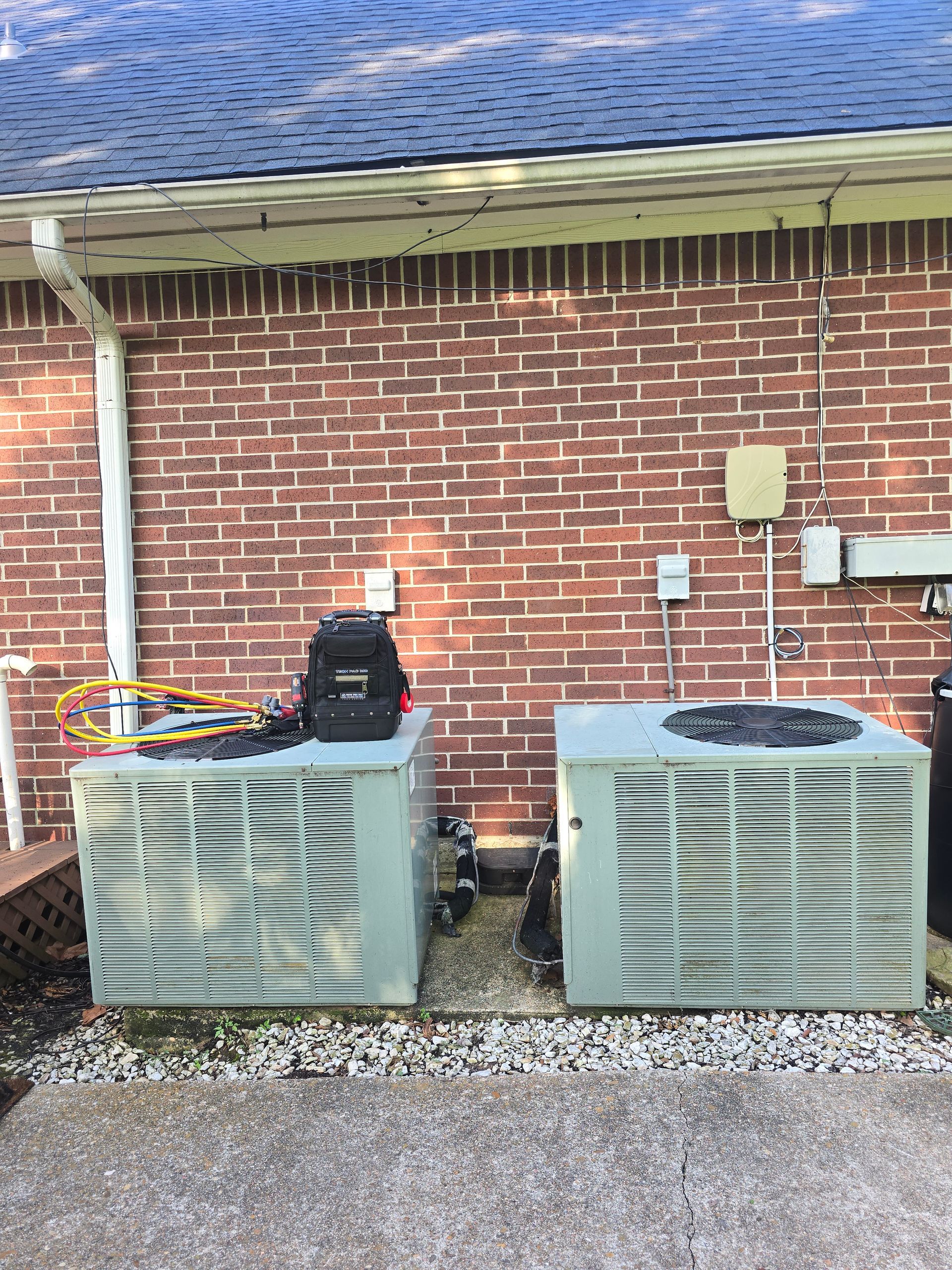 HVAC refrigerant gauges showing pressure readings during AC service by Arnett Mechanical