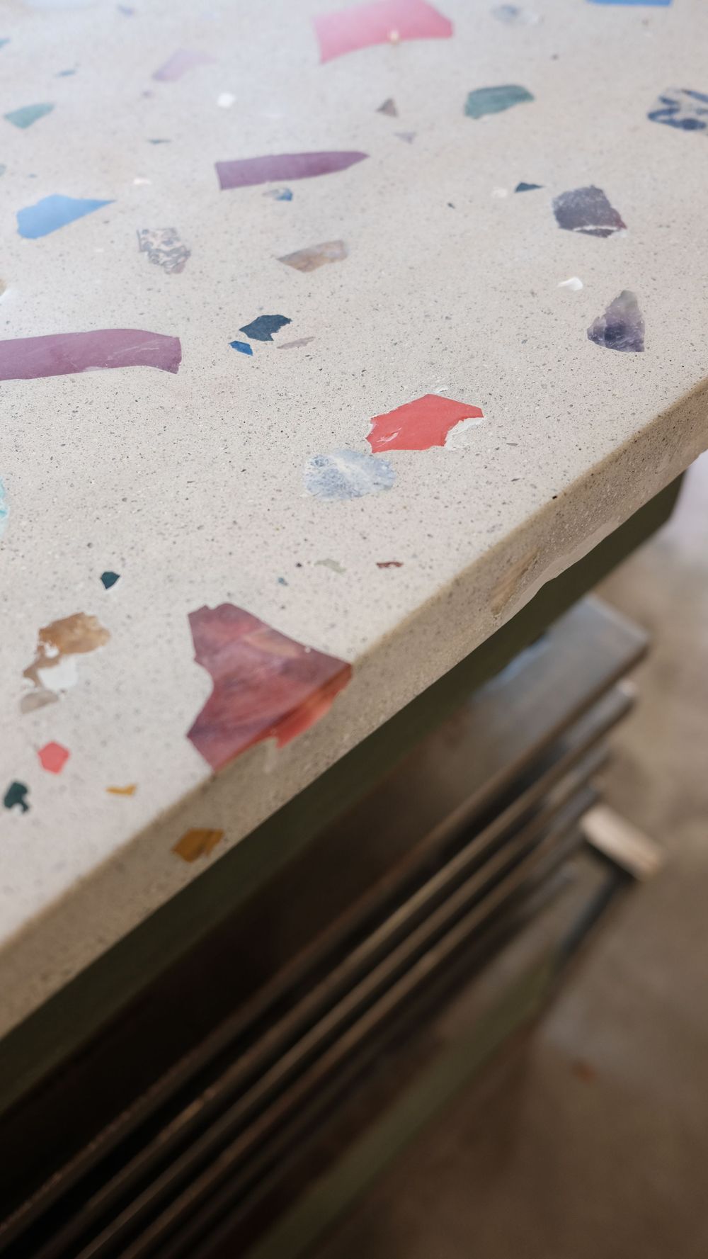 A close up of a table with a colorful terrazzo top.