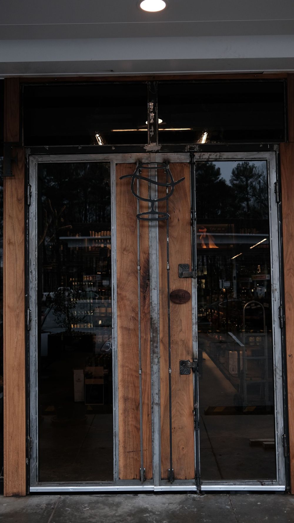 A door with a cross on it is open to a store.