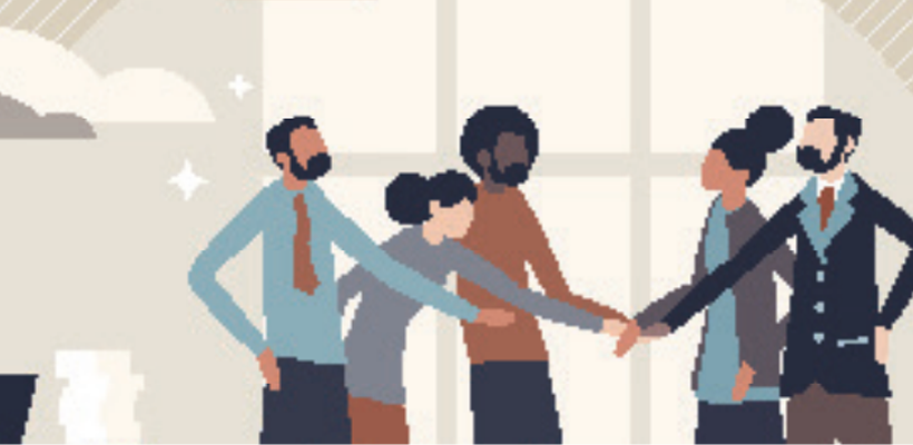 Five coworkers in suits stand in a circle, holding hands in a team huddle against a light background.
