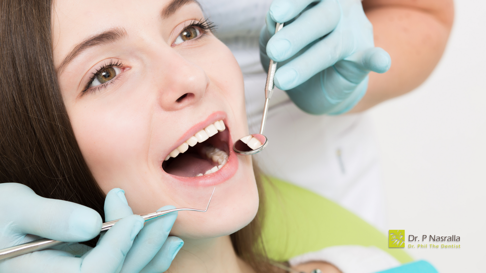 A woman is getting her teeth examined by a dentist.