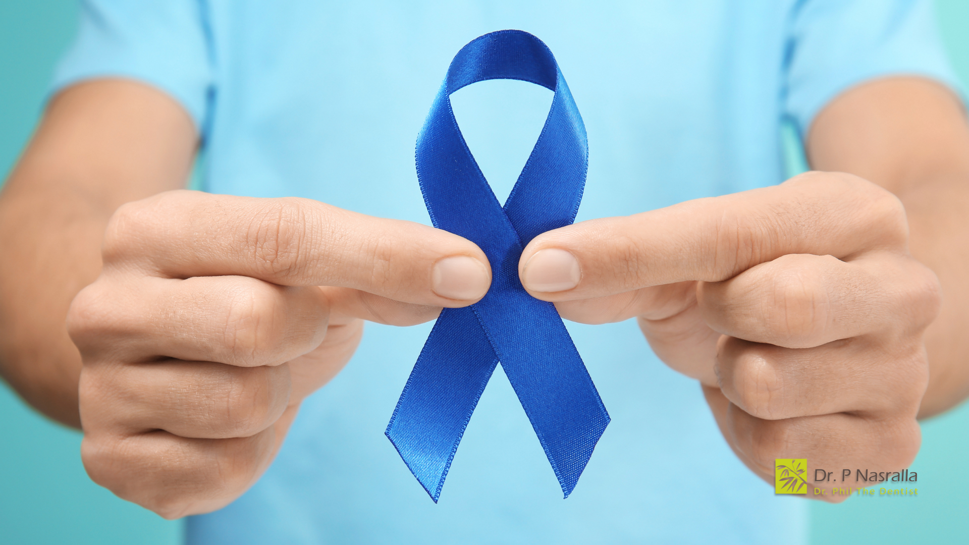 A person is holding a blue ribbon in their hands.