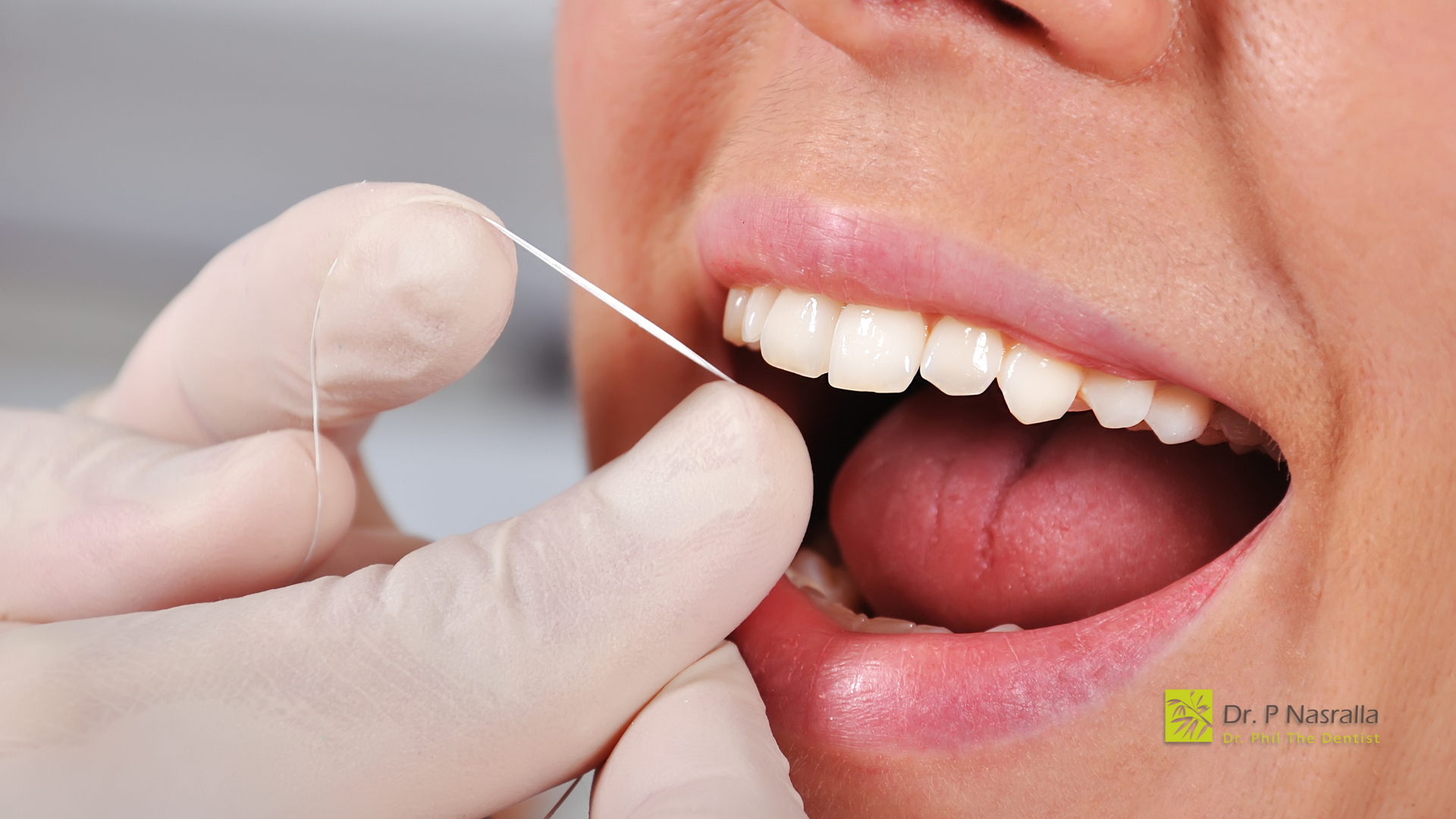 A person is flossing their teeth with a dental floss.