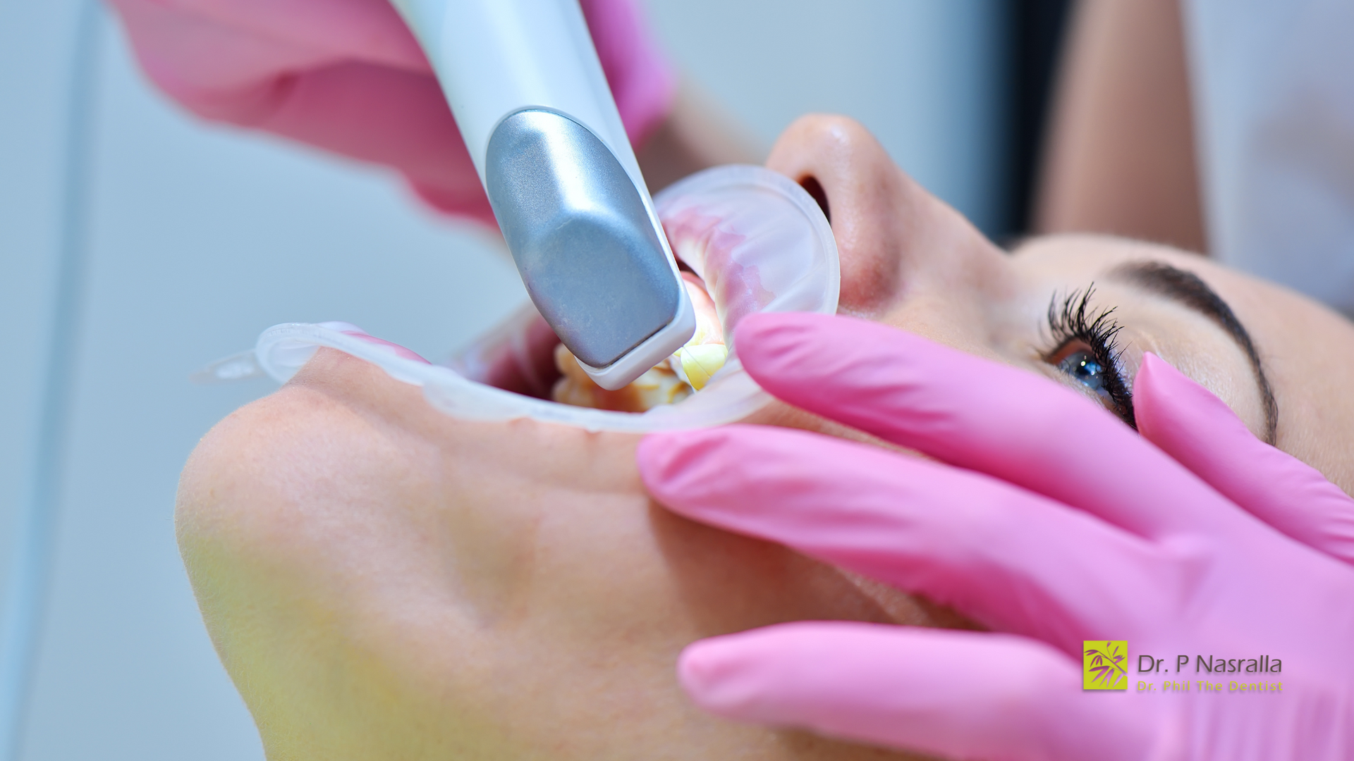 A woman is getting her teeth cleaned by a dentist.