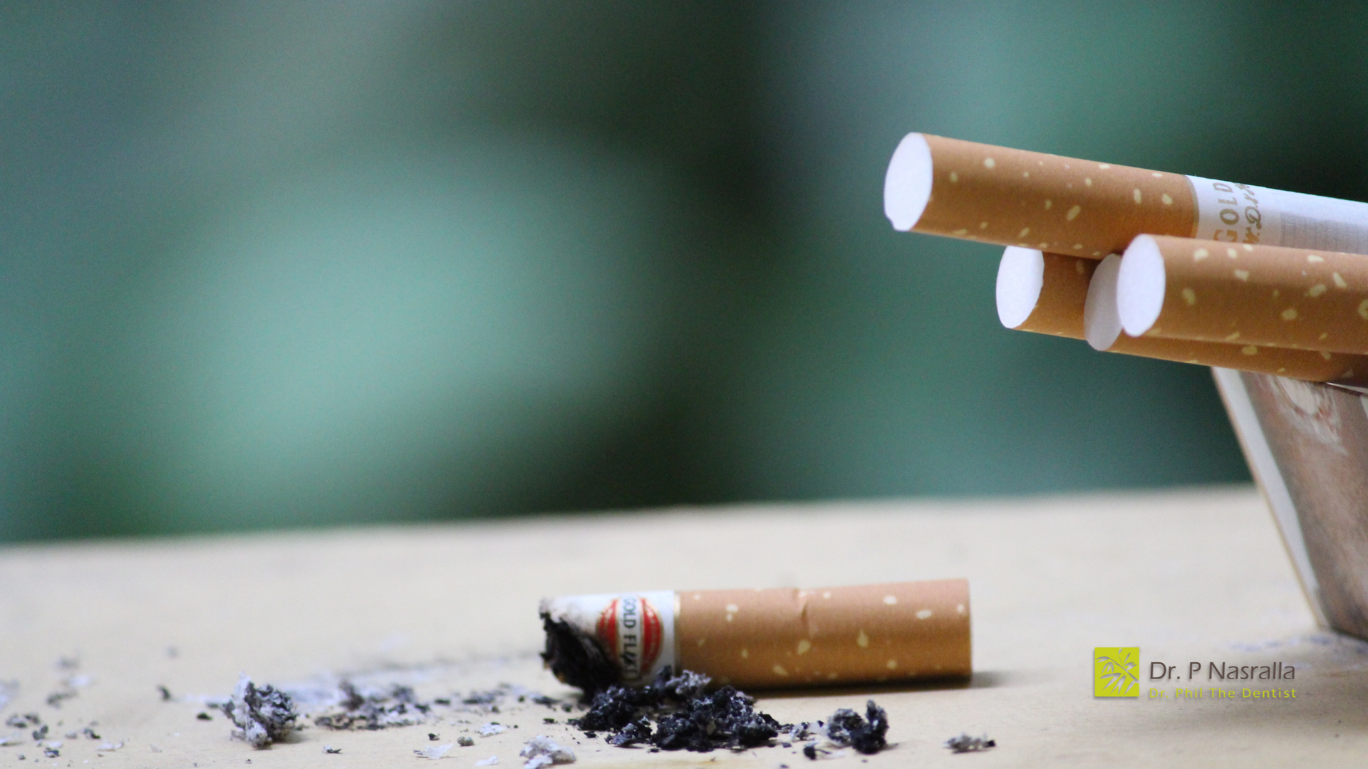 A stack of cigarettes sitting on top of an ashtray on a table.