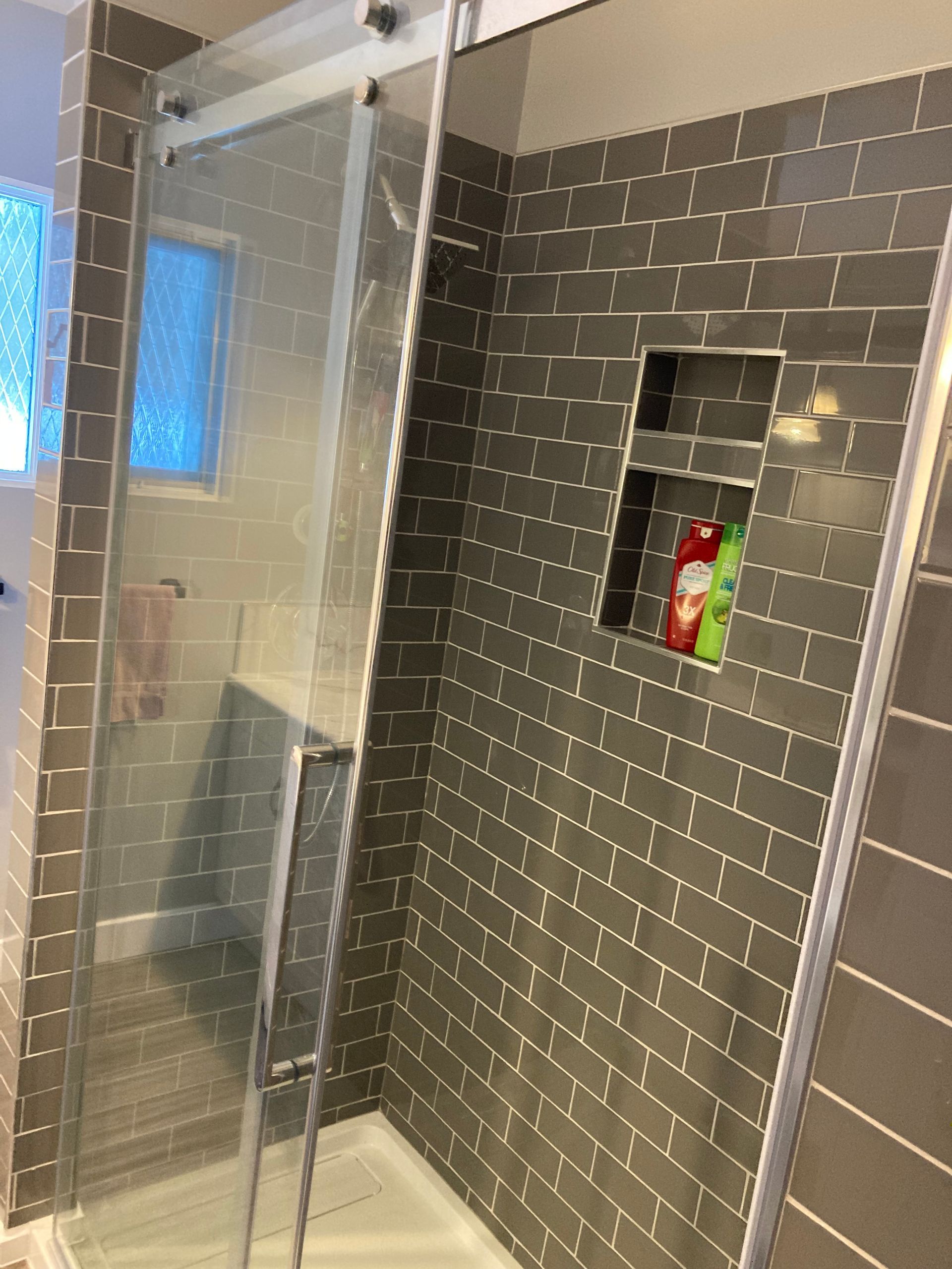 Standup shower tile and sliding glass door