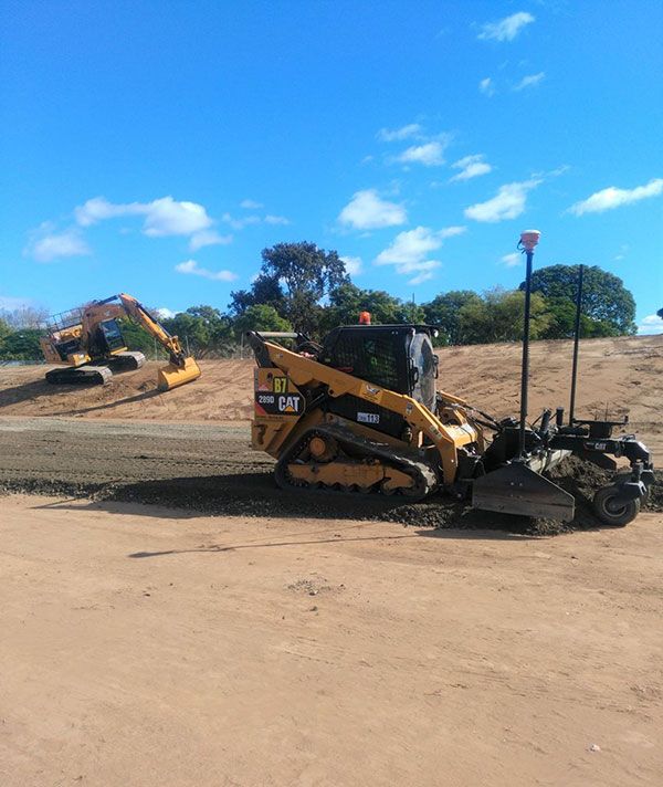 A cat bulldozer is working on a dirt road