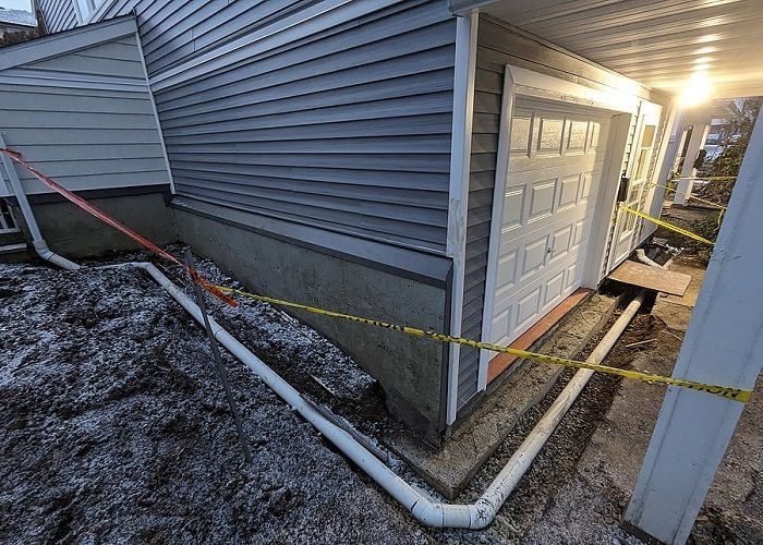 Replacing a foundation drain system with new PVC pipes installed to BC building codes