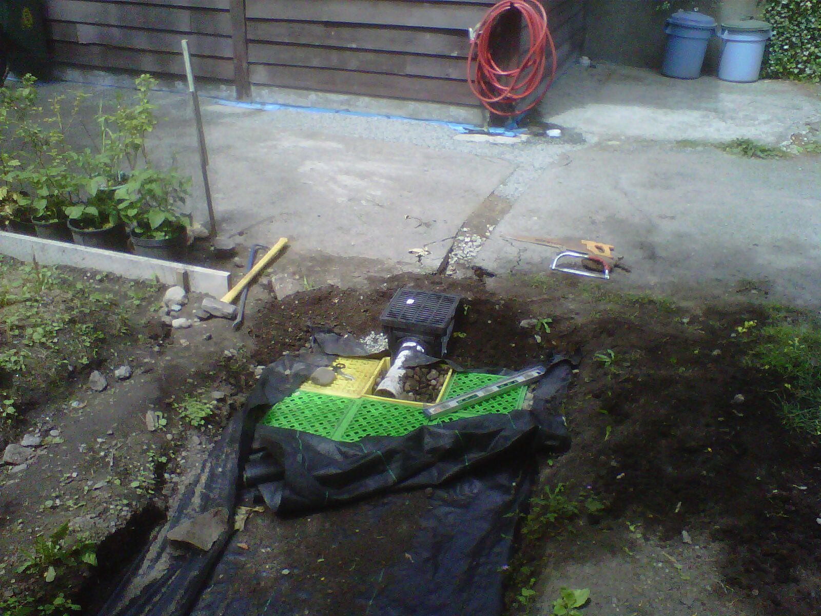 Another view of new rainwater harvesting system being installed to replace old drain tile