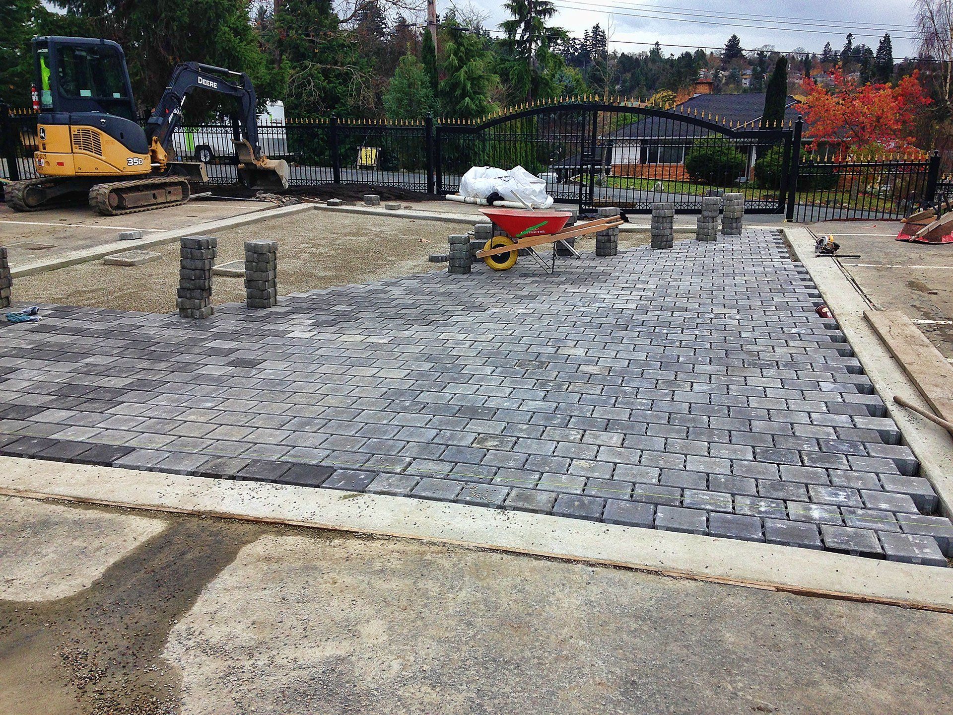 Pavers placed on top of drain cloth and drain rock as part of a permeable surface for rainwater harvesting system