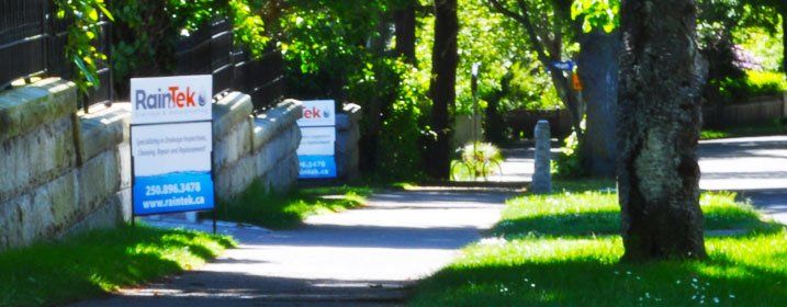 An image showing RainTek signage on the side of a sidewalk in Victoria BC