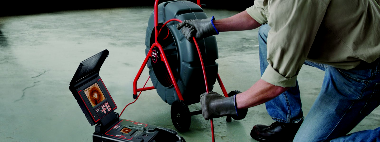 Victoria drain scope tool behind held by drainage expert